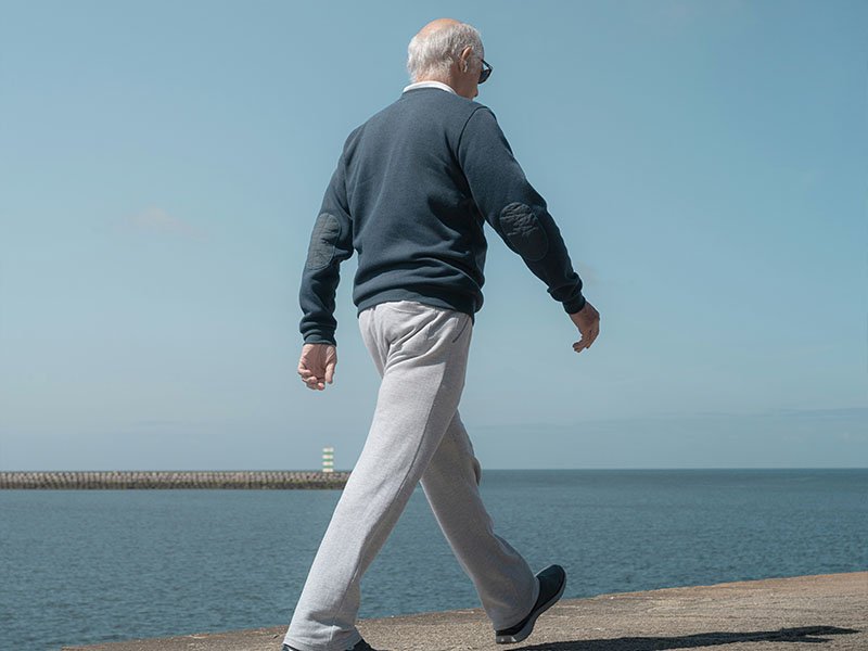Senior at beach how to walk away lower back muscle strain